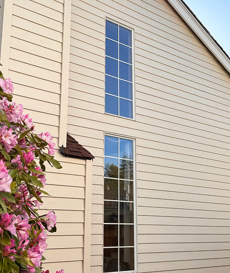 Beige lap siding close up with grid windows