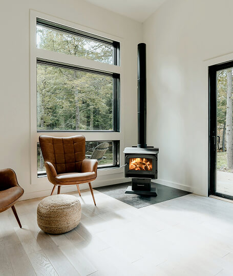 Sitting room black picture windows with wood stove